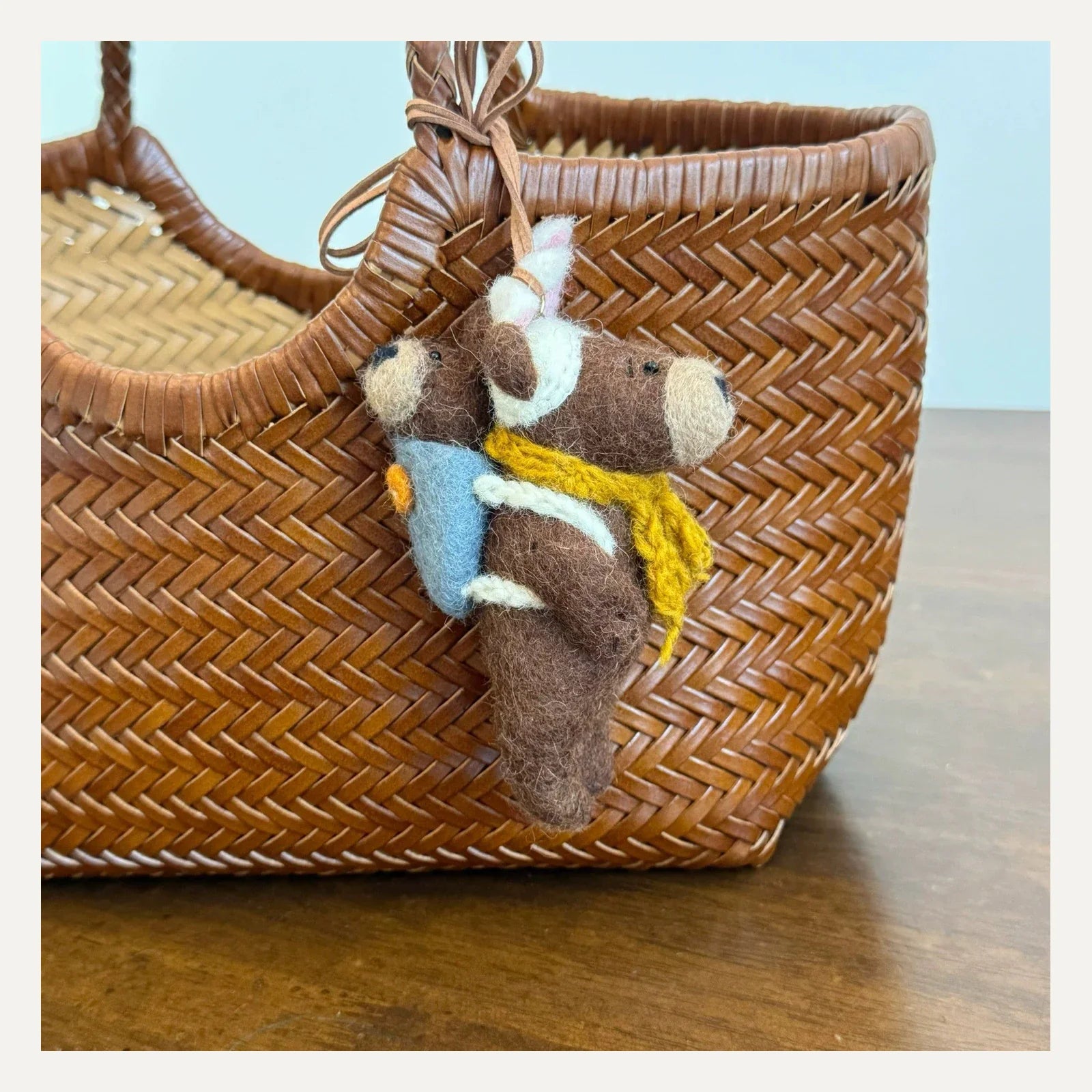 Handmade wool felt bear and cub bag charm shown from the side