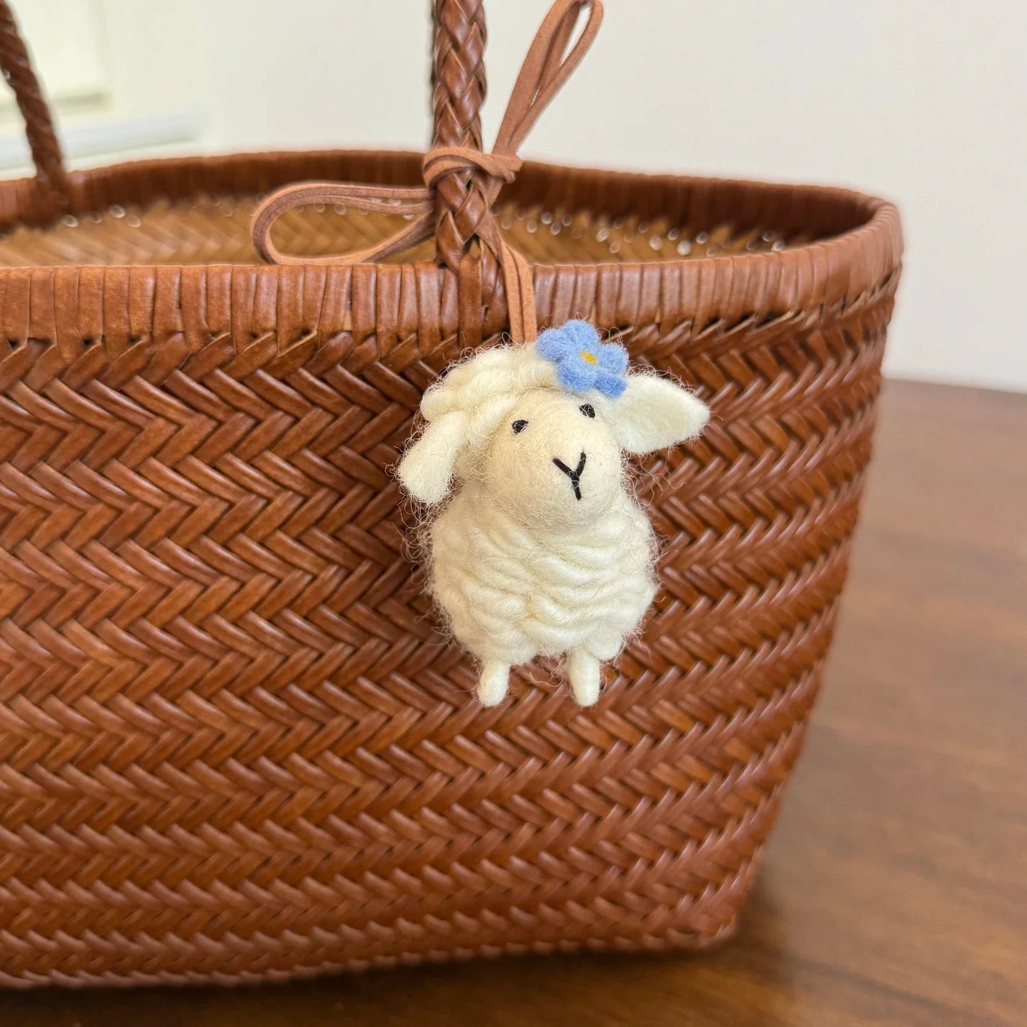Cream wool felt sheep charm with blue flower detail