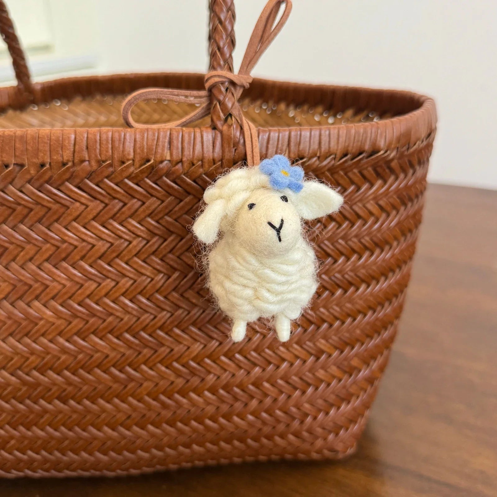 Cream wool felt sheep charm with blue flower detail