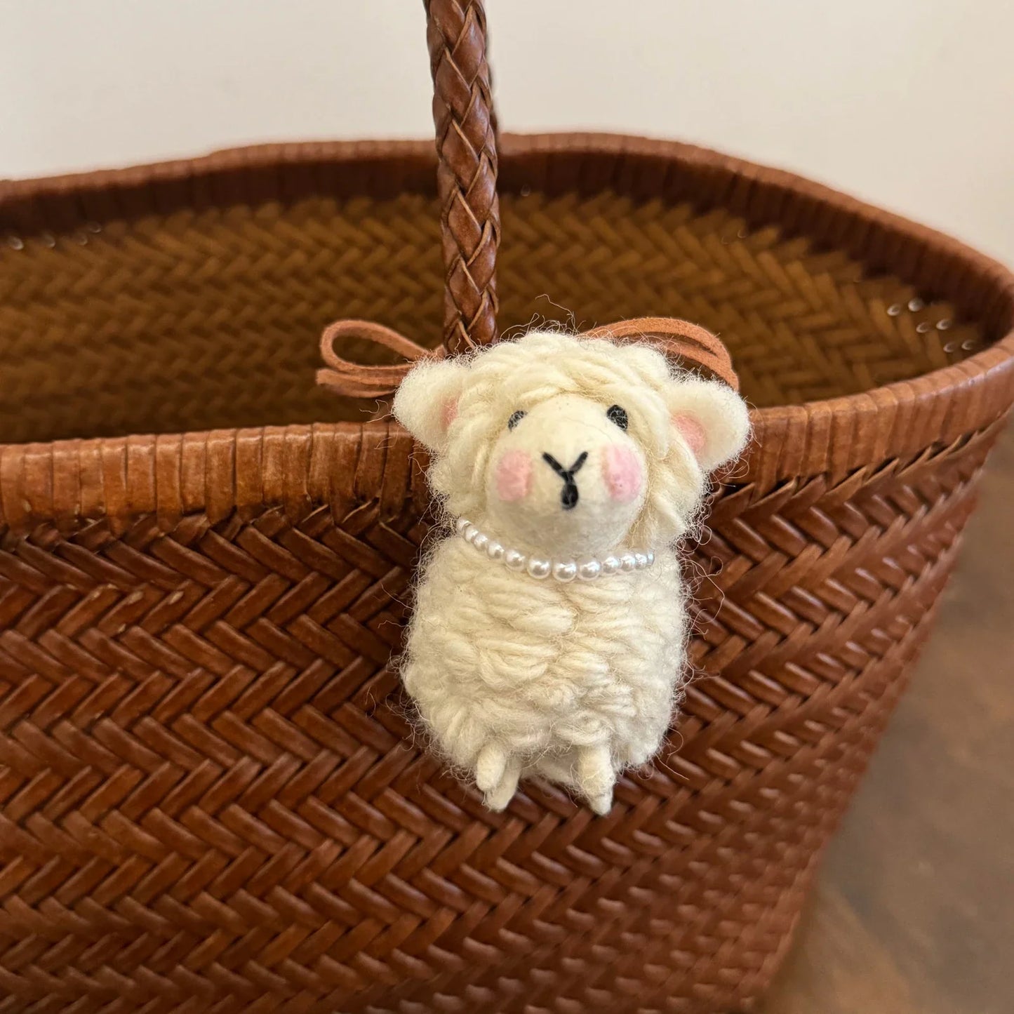 Cream wool felt sheep charm with blush cheeks and removable pearl necklace