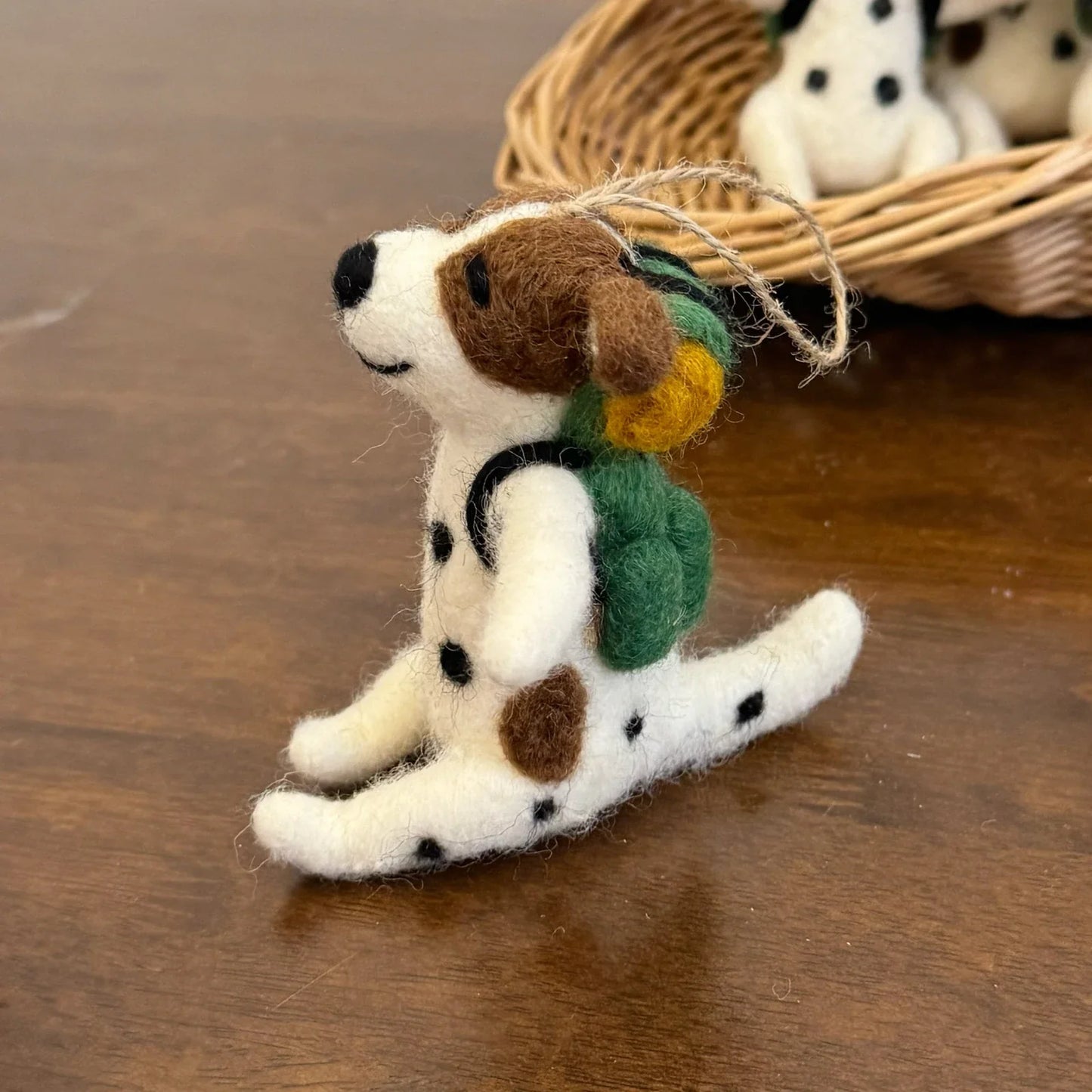 Side view of a handmade wool felt Dalmatian dog charm