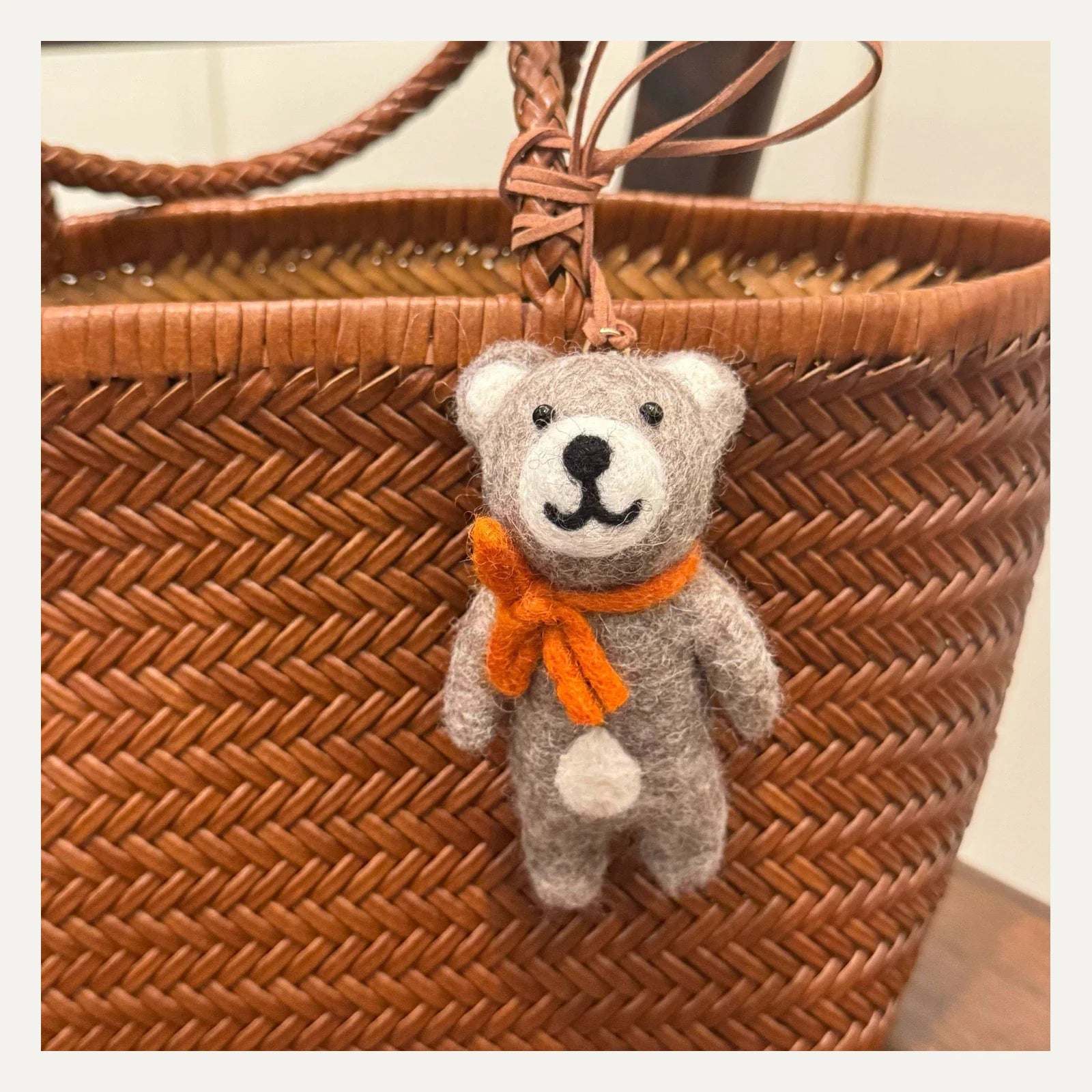 Handmade gray wool felt bear bag charm with orange scarf and leather cord