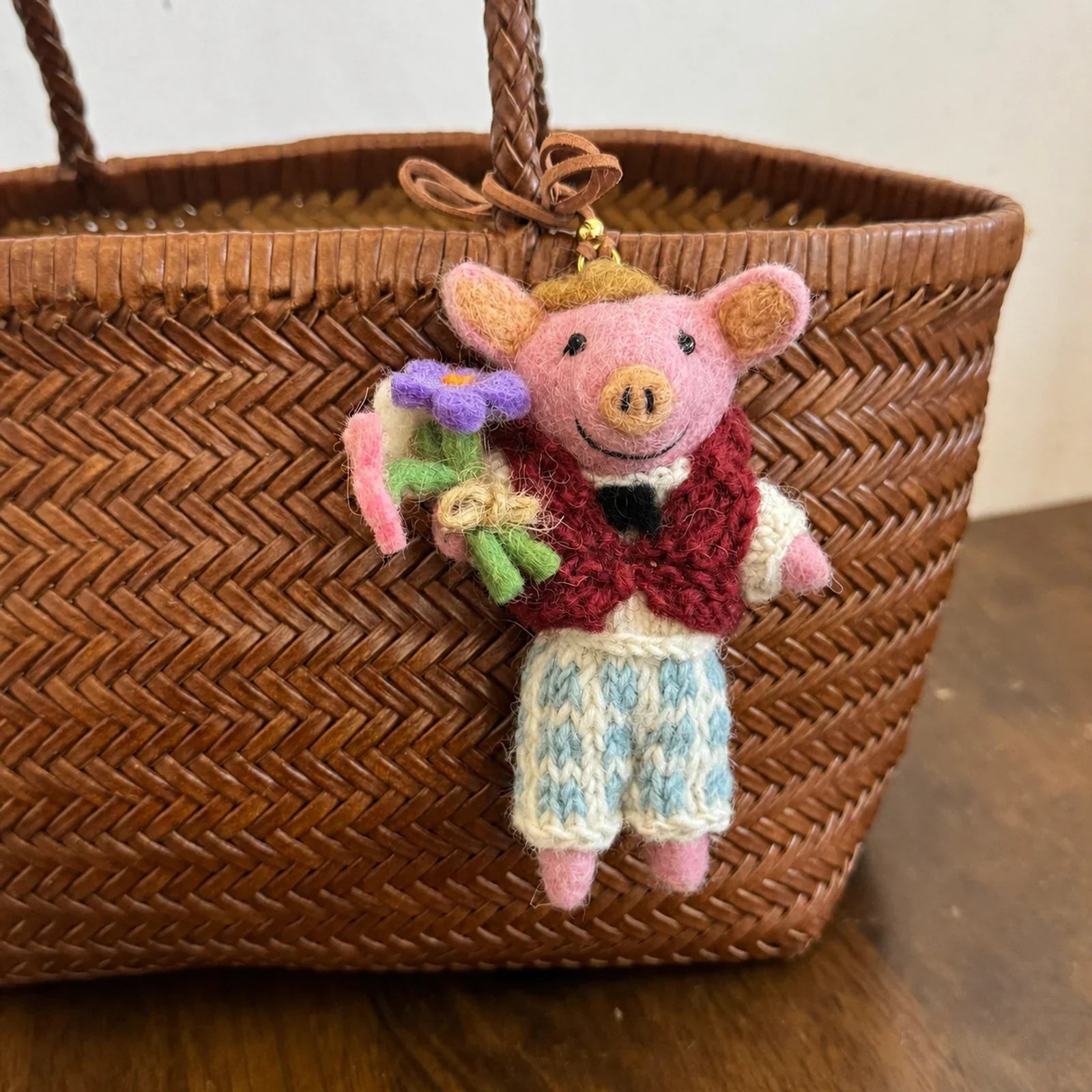 Handmade wool felt pig charm with a vest and flowers