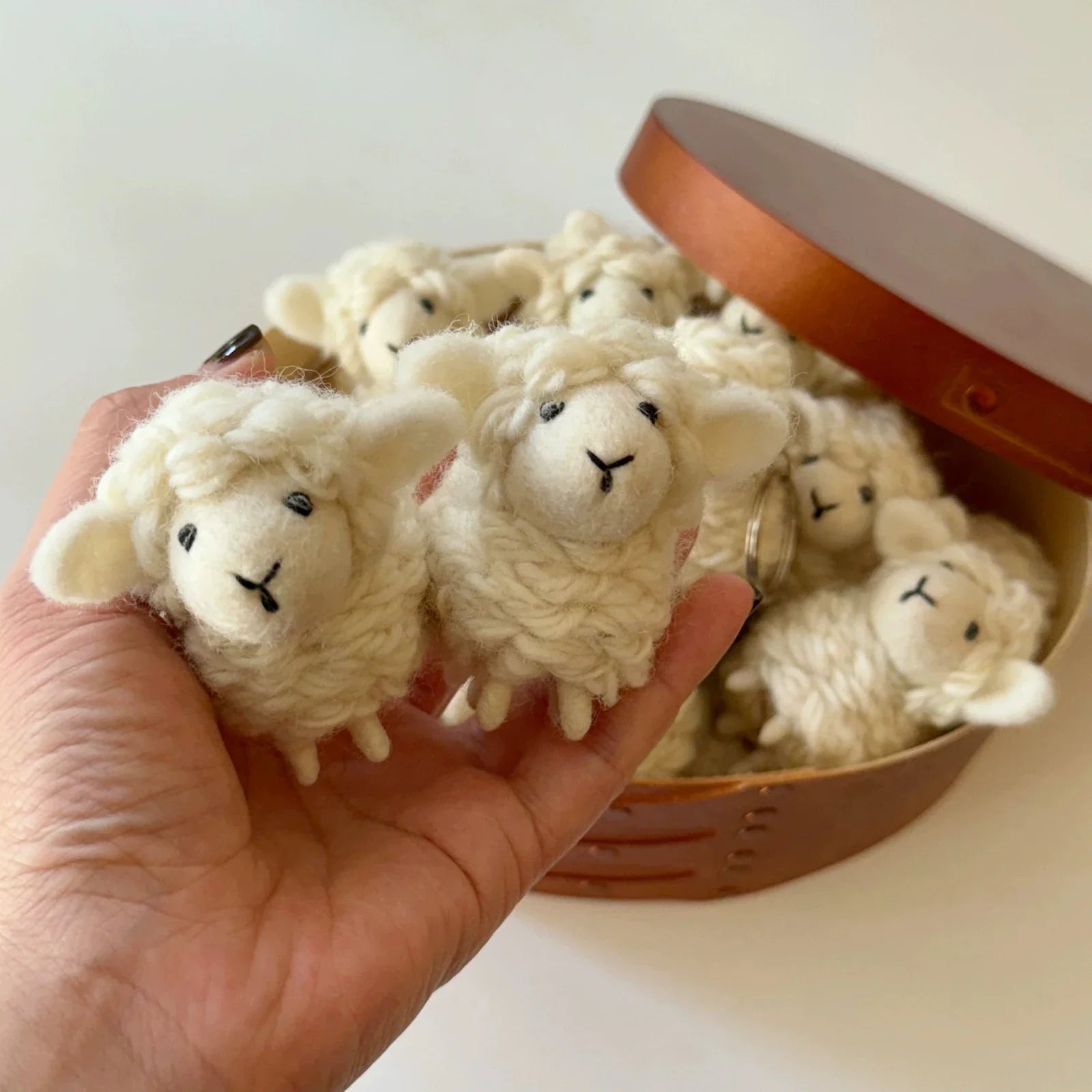 Handheld group of soft wool felt sheep charms