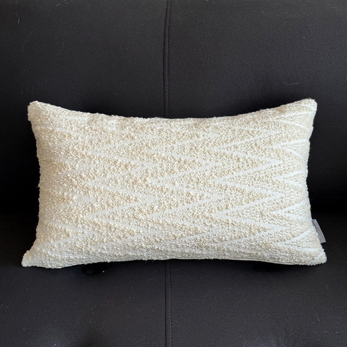 Light beige lumbar cushion, styled