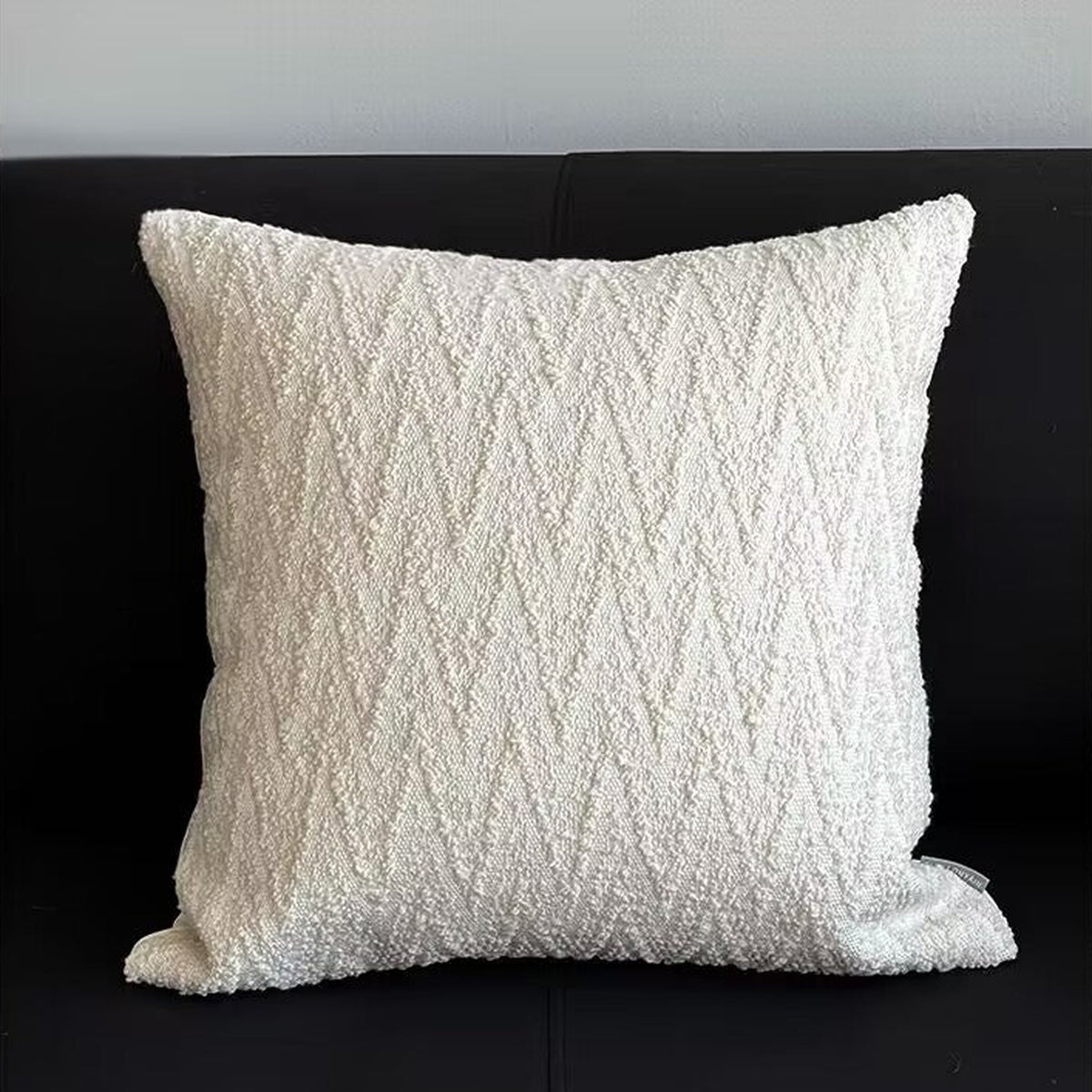Light beige square cushion, styled