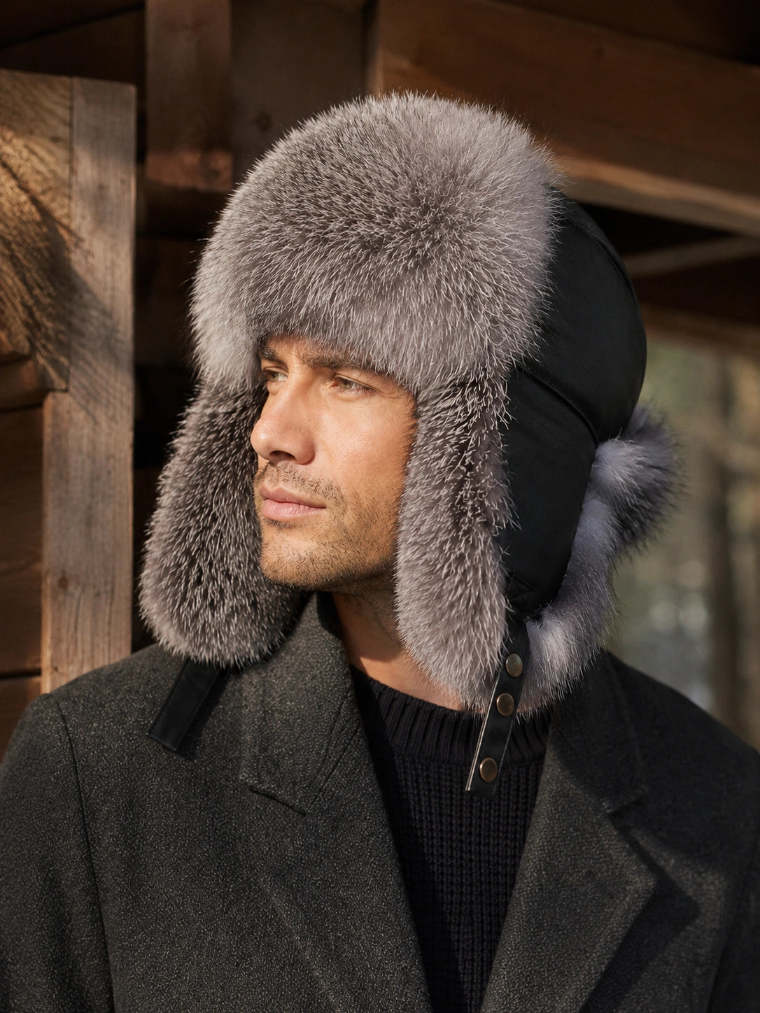 Man in a Silver Gray Fox fur trapper hat in warm cabin light