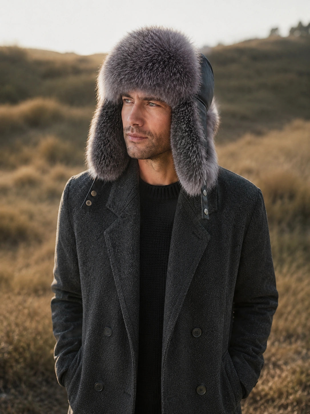 Man styling a Silver Gray Fox fur trapper hat in a winter field