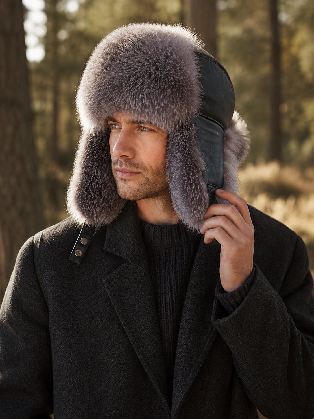 Man wearing a Silver Gray Fox fur trapper hat in a winter forest