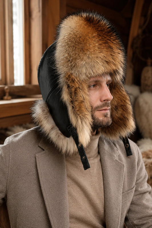 Men wearing a natural raccoon and fox fur leather trapper hat in a warm cabin