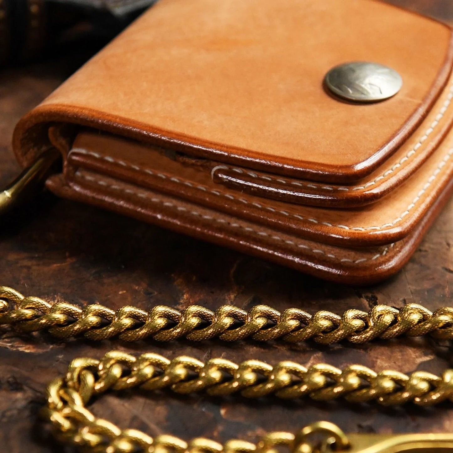 Close view of the metal chain texture beside a leather wallet
