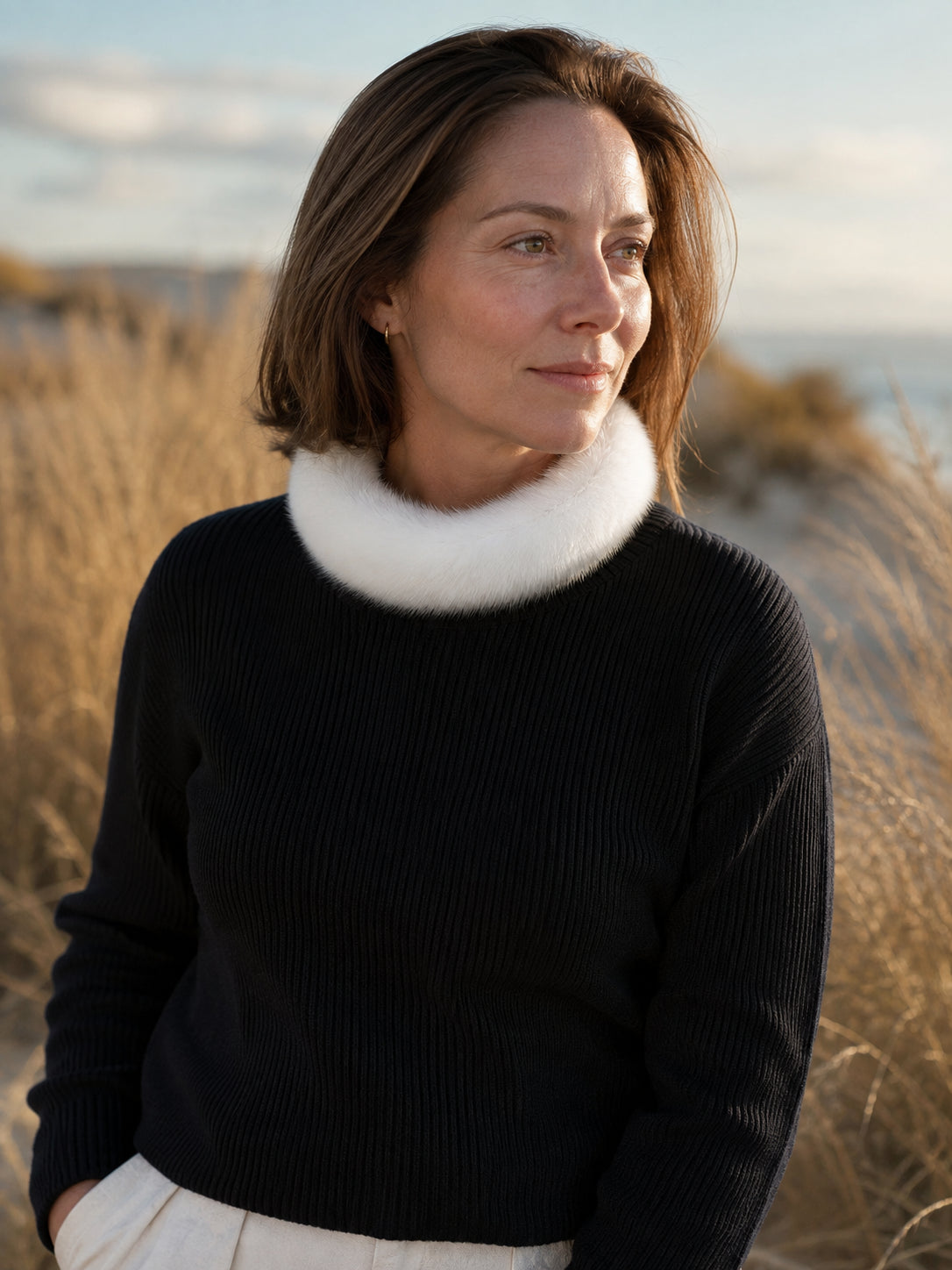 Woman wearing an ivory mink fur circular collar scarf outdoors