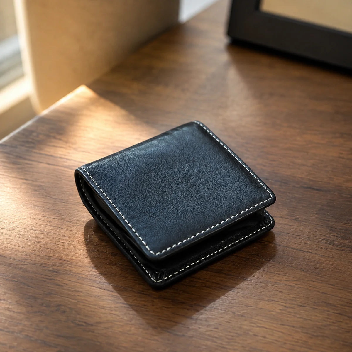 Deep navy leather coin purse in warm natural light