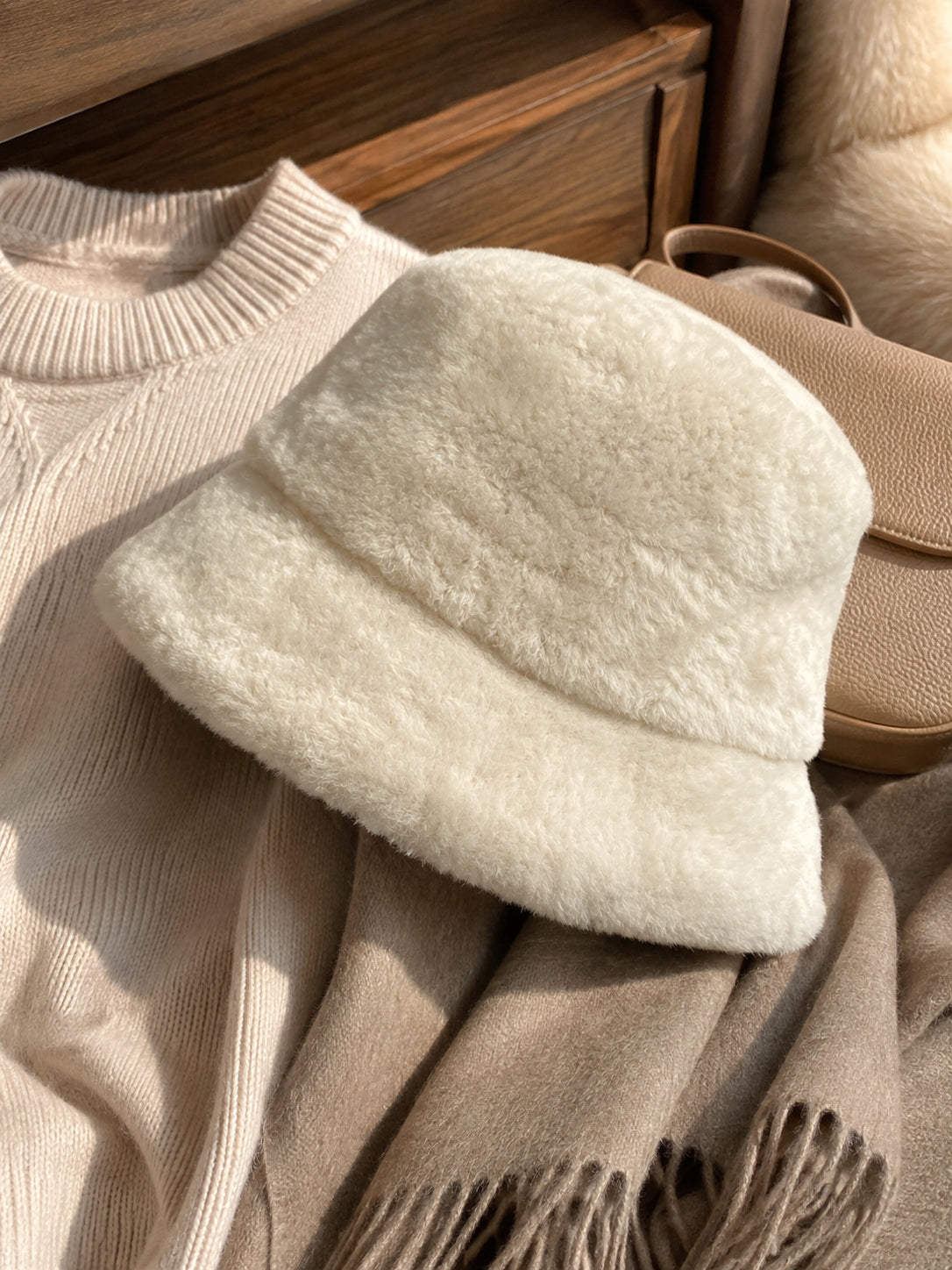 Off-White short-brim bucket hat styled with neutral knitwear