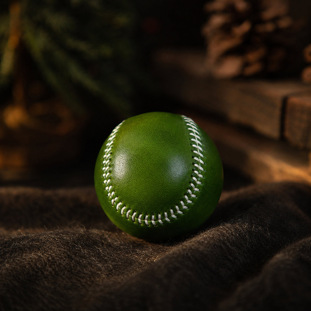 Olive green leather baseball with contrasting hand stitching