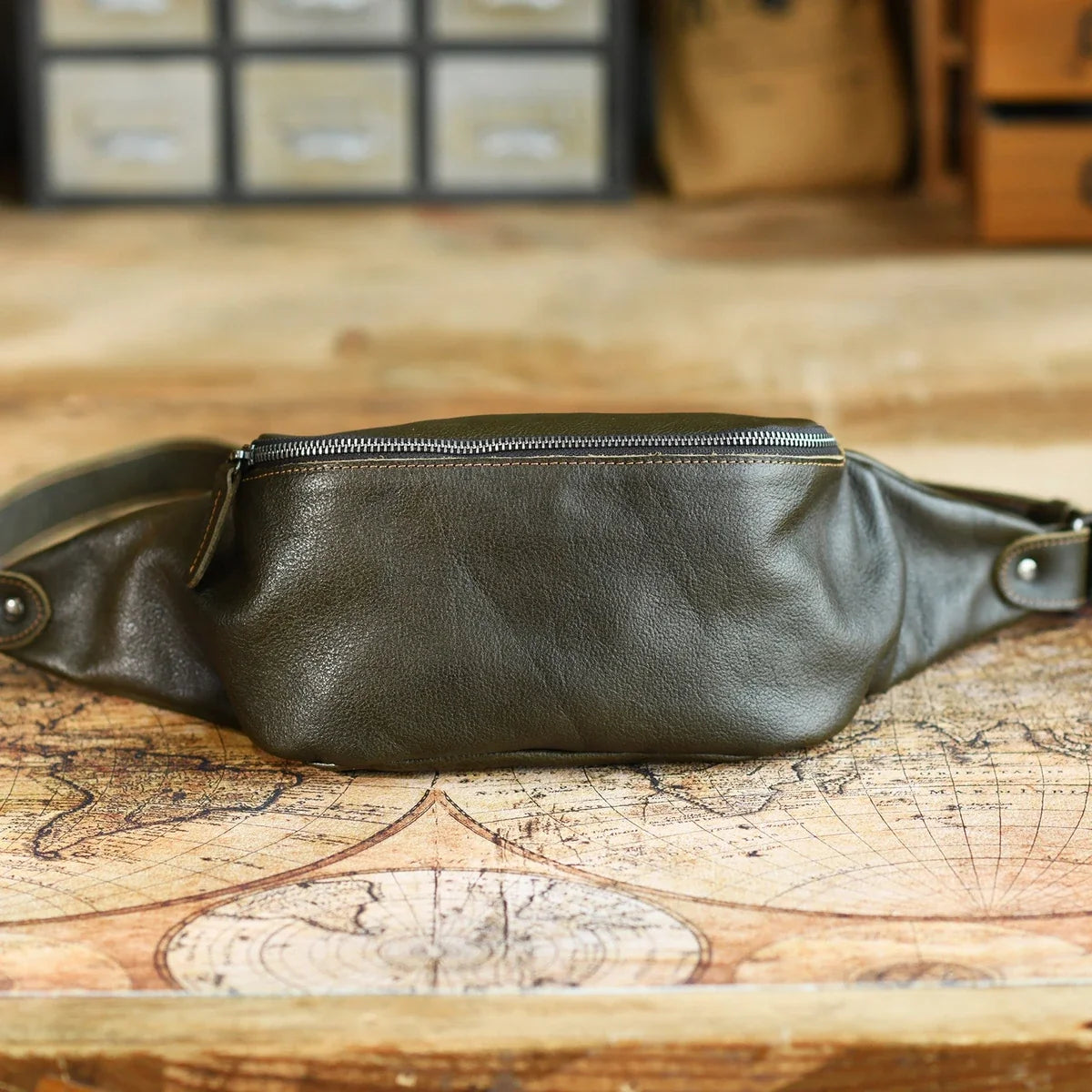 Olive green vegetable-tanned leather sling bag