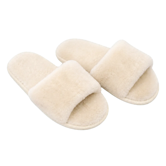 Capricornus Living Ivory White genuine Australian shearling slide slippers on a transparent background