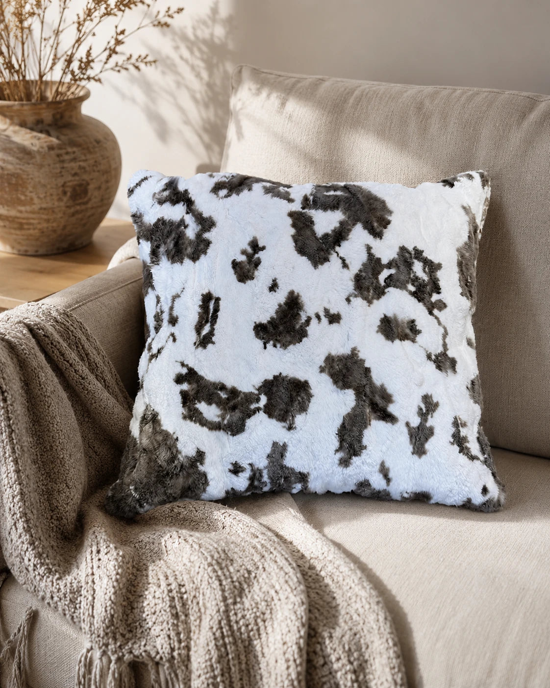 Capricornus Living White Coffee Abstract rabbit fur throw pillow styled on an accent chair