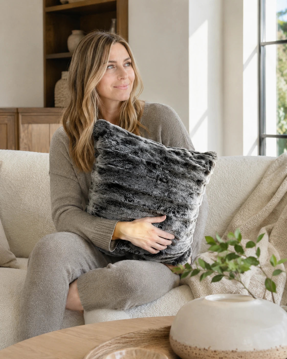 Capricornus Living Moonlit Gray rabbit fur pillow in a warm living room