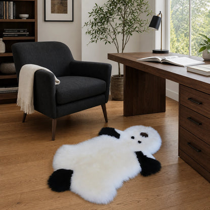 Capricornus Living White and black genuine sheepskin puppy rug in an American home office