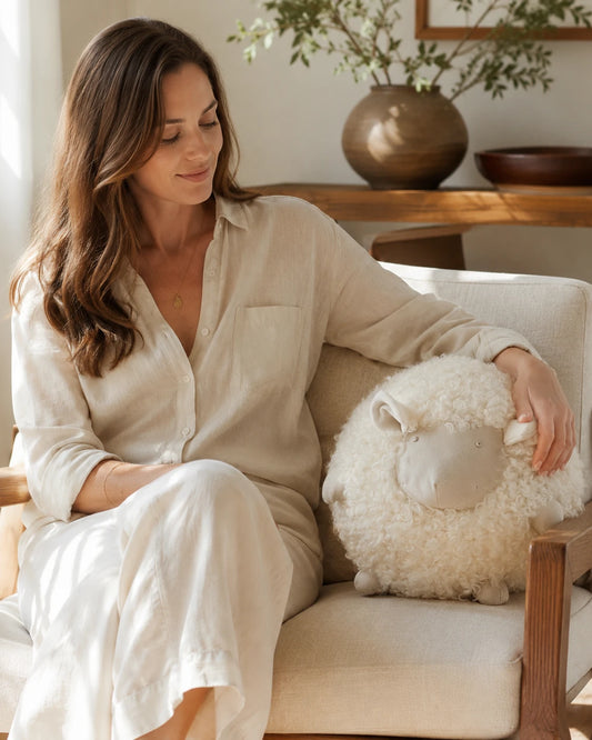 Capricornus Living Cream White sheep pillow used on a neutral sofa