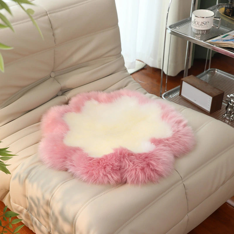 Capricornus Living Rose Pink Border and Ivory Center sheepskin flower chair pad on a chair
