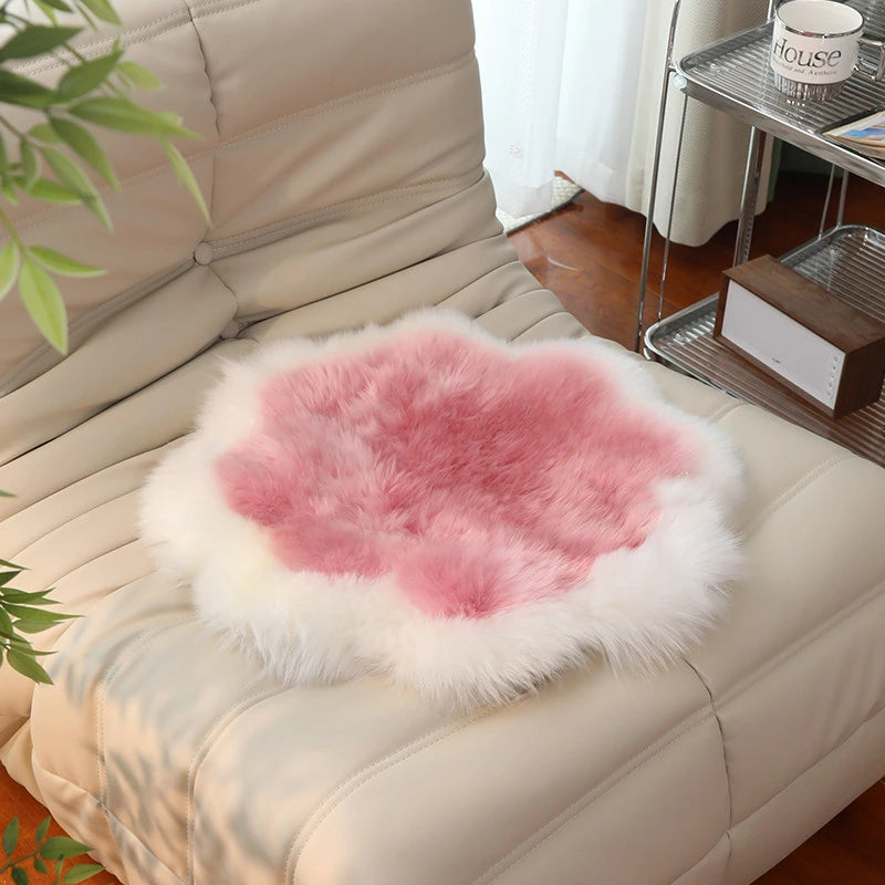 Capricornus Living Ivory Border and Rose Pink Center sheepskin flower chair pad on a chair
