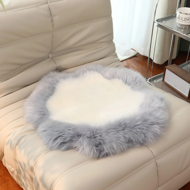 Capricornus Living Silver Gray Border and Ivory Center sheepskin flower chair pad on a chair