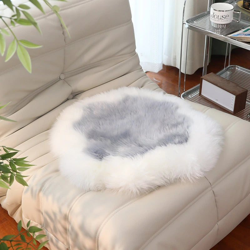 Capricornus Living Ivory Border and Silver Gray Center sheepskin flower chair pad on a chair