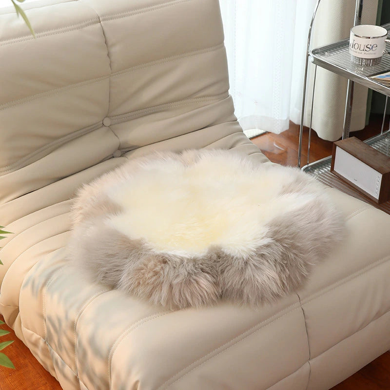 Capricornus Living Taupe Border and Ivory Center sheepskin flower chair pad on a chair