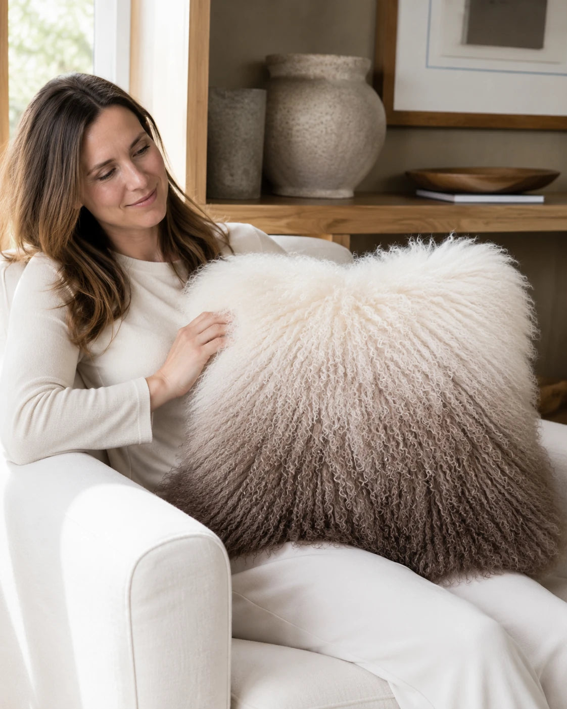 Capricornus Living Brown Gradient lamb wool pillow on a lounge chair