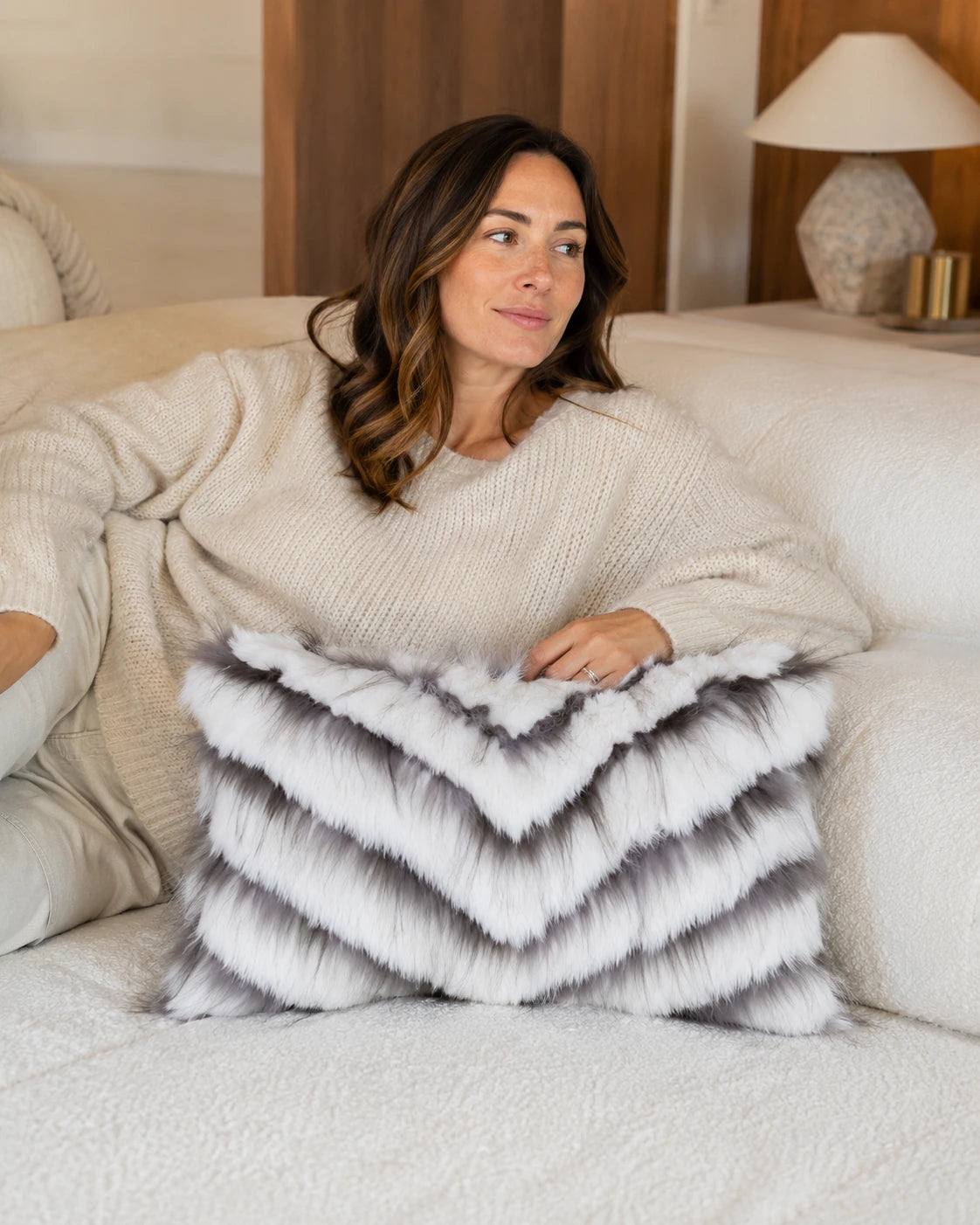 Capricornus Living Adult using an Ivory White lumbar genuine fur chevron pillow on a sofa