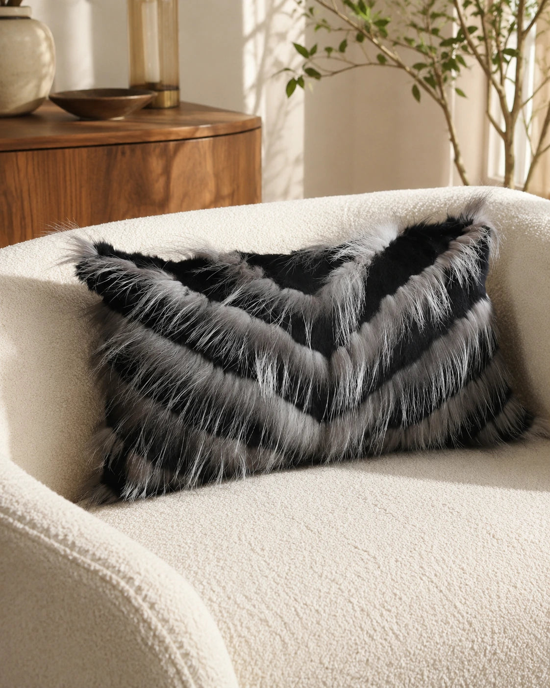 Capricornus Living Black lumbar genuine fur chevron pillow on a cream sofa