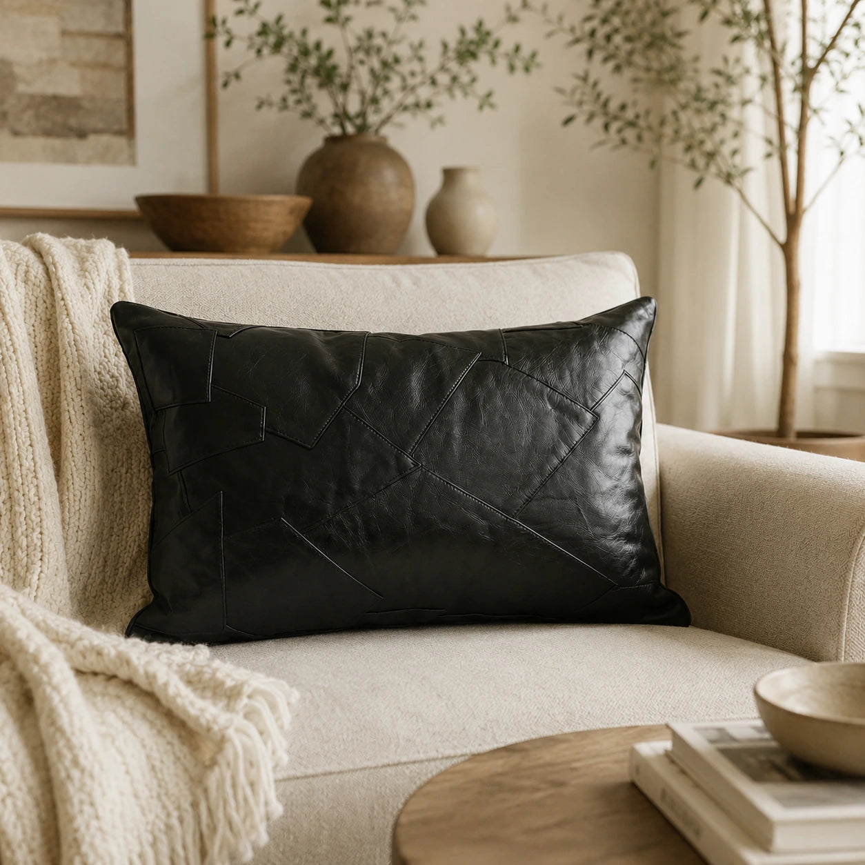 Capricornus Living Architectural Black lumbar genuine cowhide patchwork pillow styled on a sofa