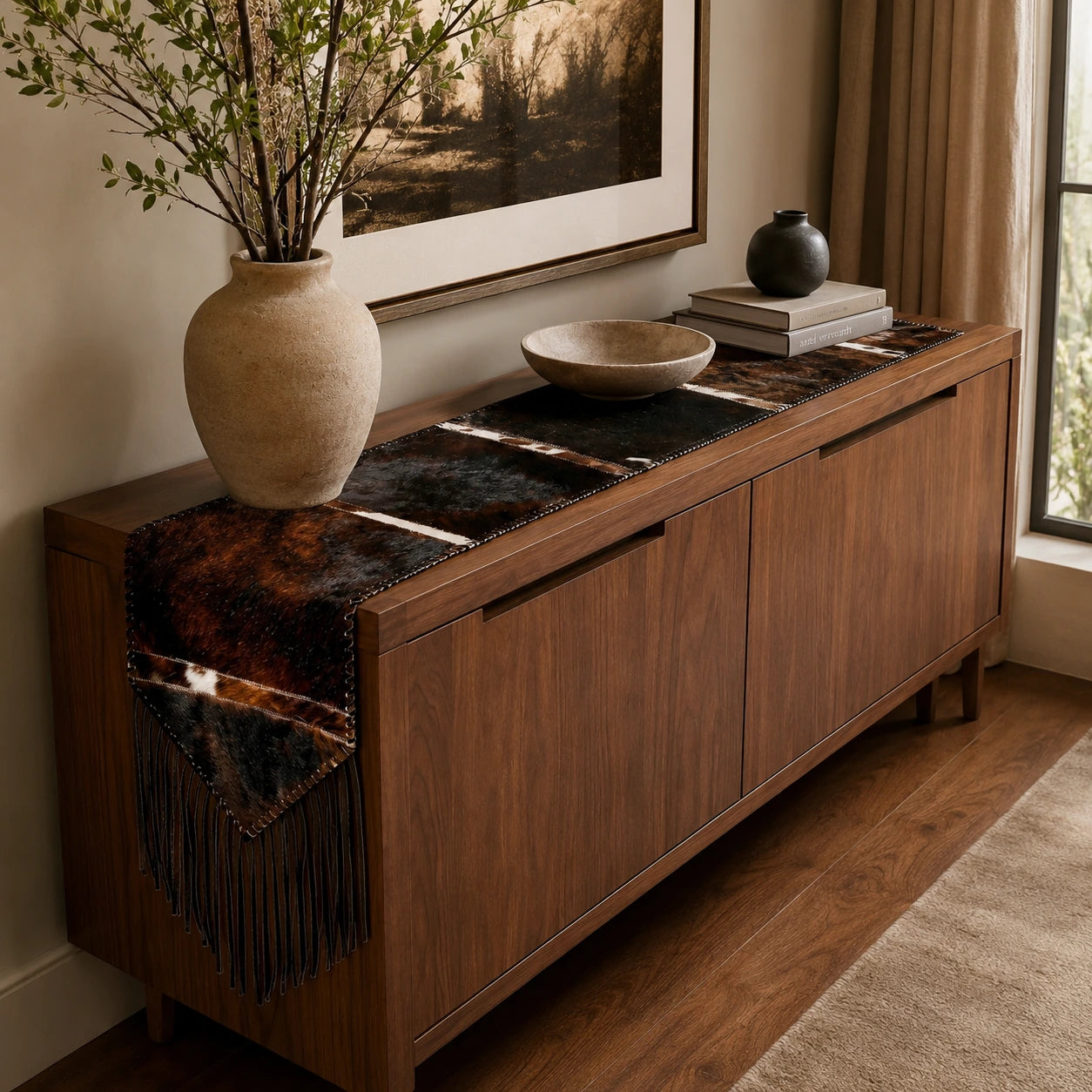 Capricornus Living Random Brown Brindle Fringe cowhide table runner styled on a console