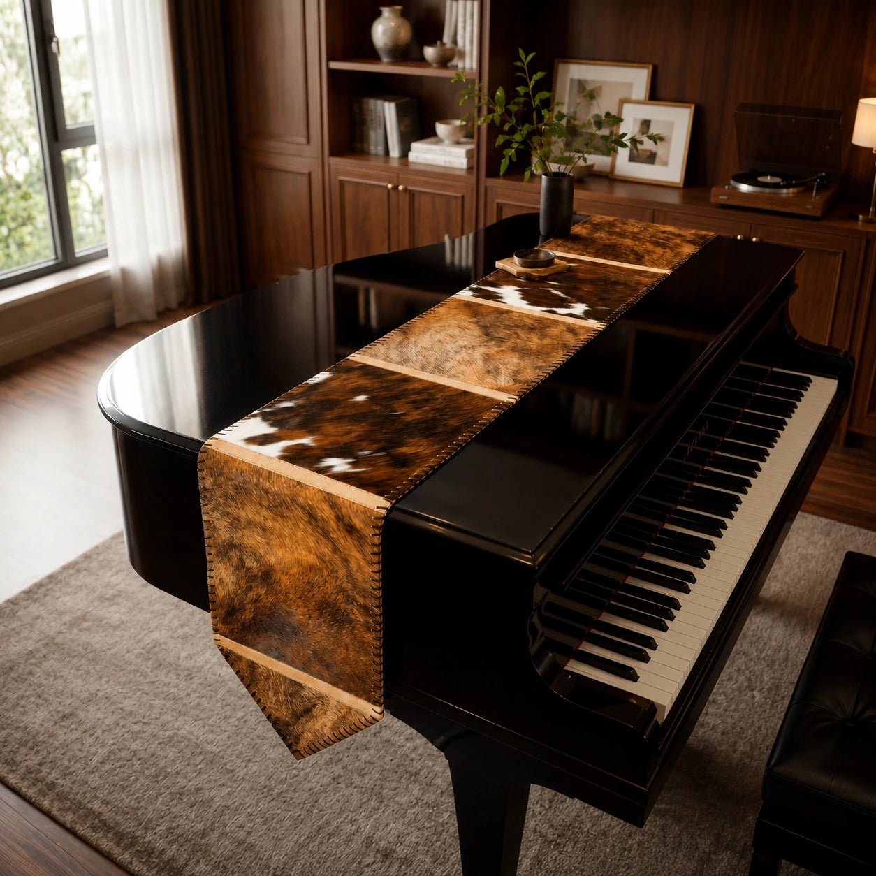 Capricornus Living Random Black-Brown Brindle cowhide table runner styled on a piano