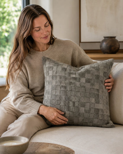 Capricornus Living Gray Woven square cowhide pillow shown at scale on a neutral sofa