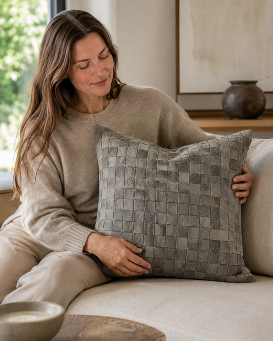 Capricornus Living Gray Woven square cowhide pillow shown at scale on a neutral sofa