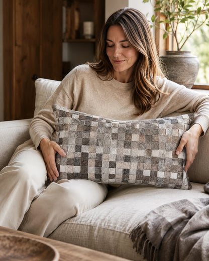 Capricornus Living Light Gray Woven lumbar cowhide pillow shown at scale on a neutral sofa