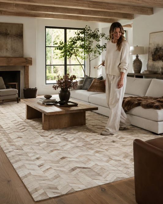 Capricornus Living Herringbone Beige genuine cowhide rug in a natural-light living room