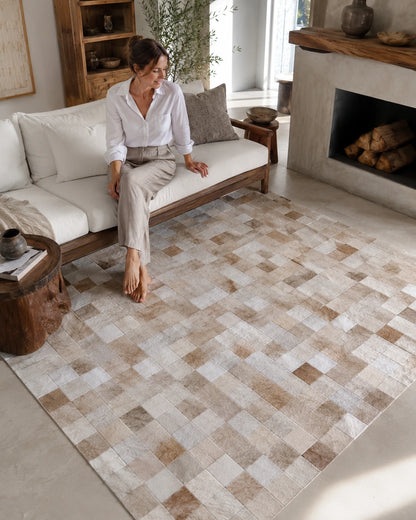 Capricornus Living Checkerboard Beige genuine cowhide rug in a sofa and reading area