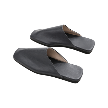 Capricornus Living Black closed-toe genuine leather house slippers from an alternate angle on a transparent background