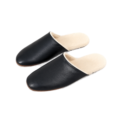Capricornus Living Black genuine lambskin plush-lined house slippers on a transparent background