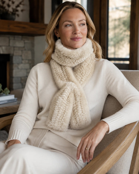 Woman over 35 wearing an ivory beige genuine mink fur long scarf in a warm lodge