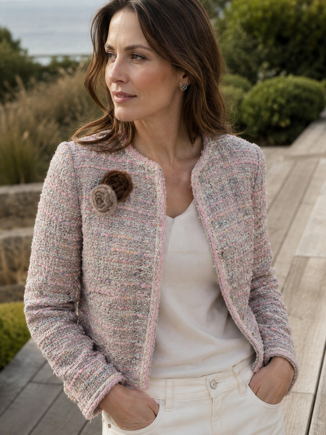 Pastel Light Brown camellia flower brooch styled with a pink tweed jacket outdoors