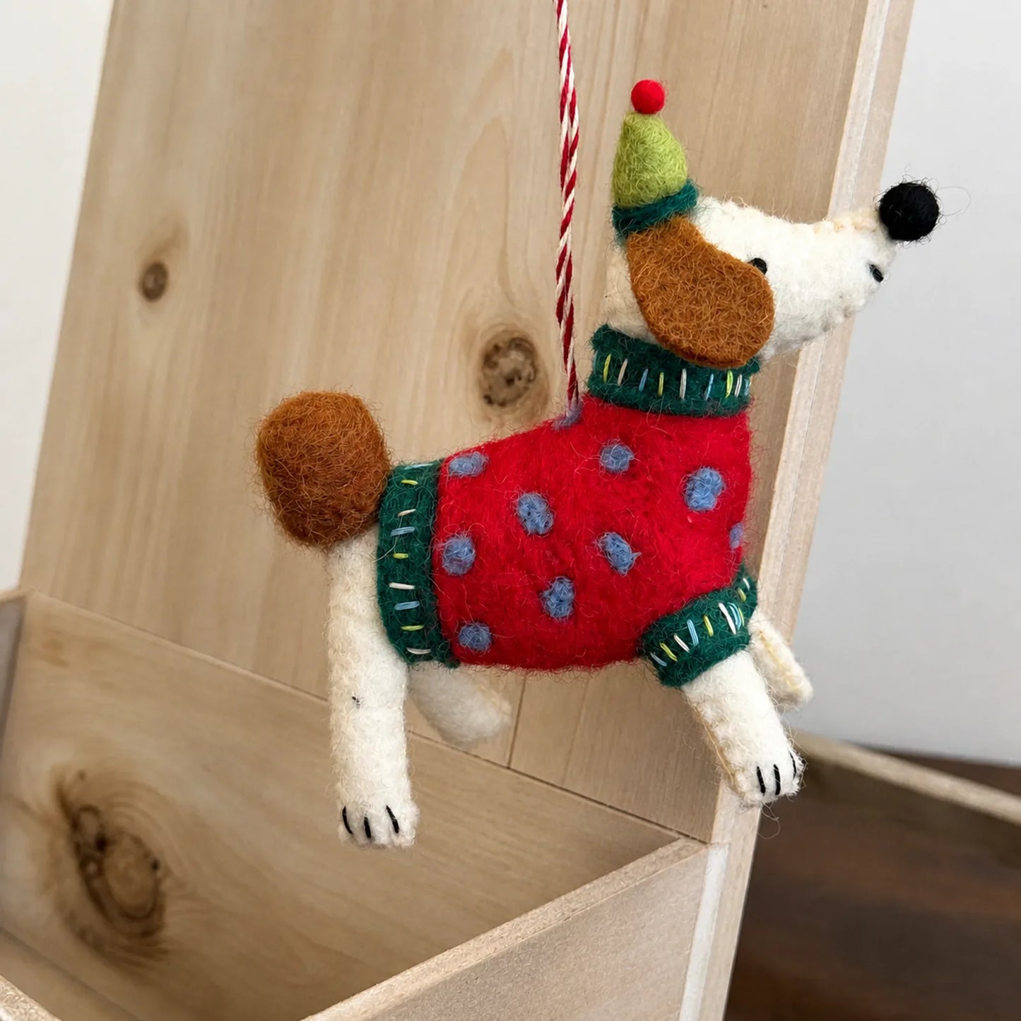 Red spotted wool felt dog ornament with hand-stitched details