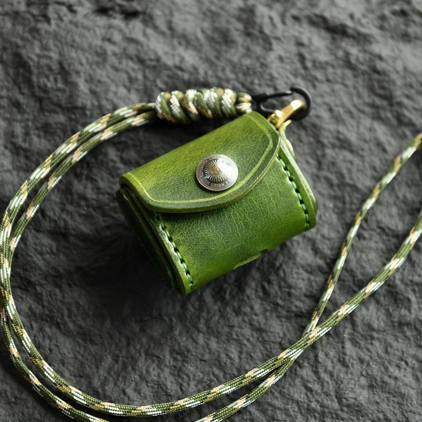Forest Green cowhide earbud case with sun medallion and neck cord