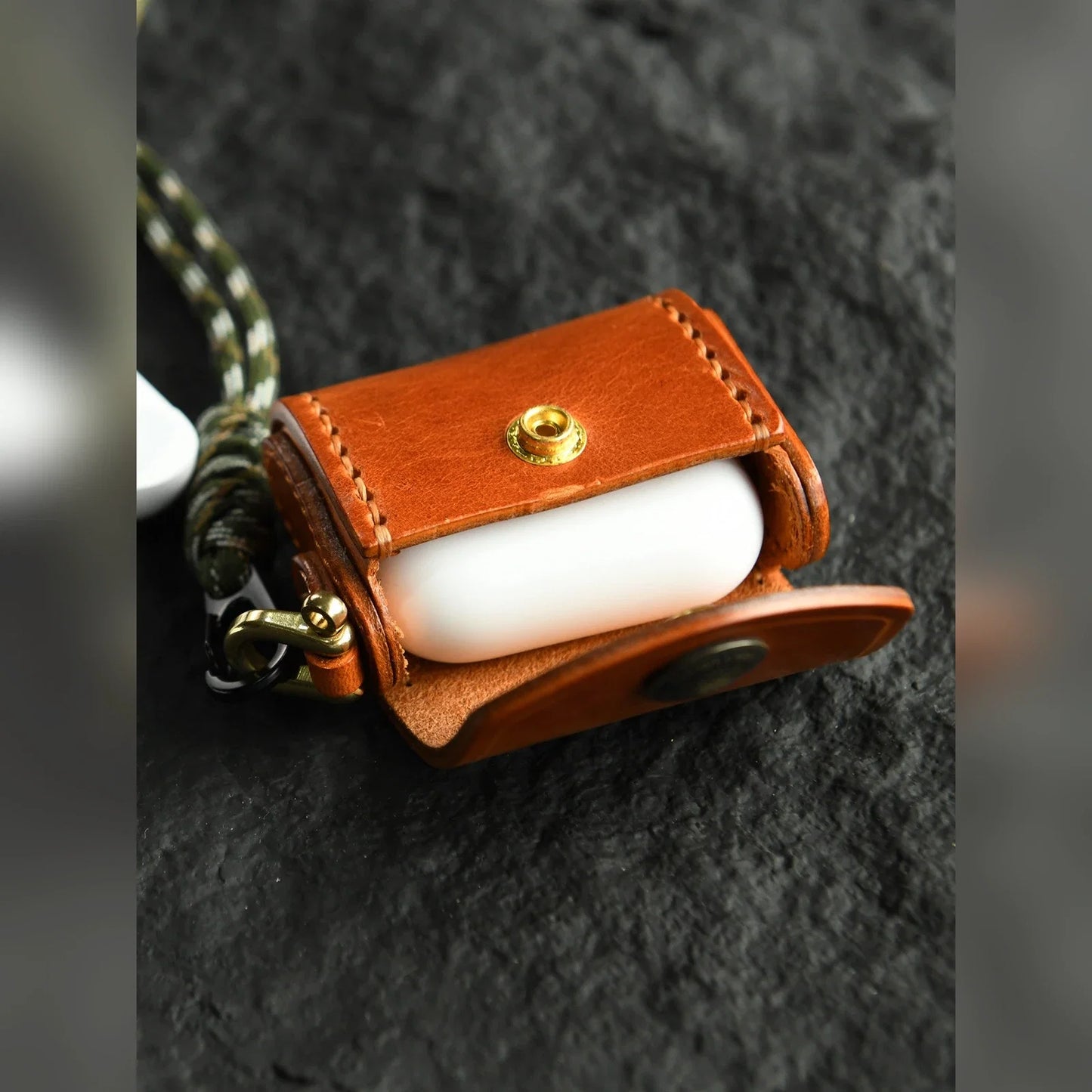 Sunset Tan hand-stitched cowhide earbud case shown open