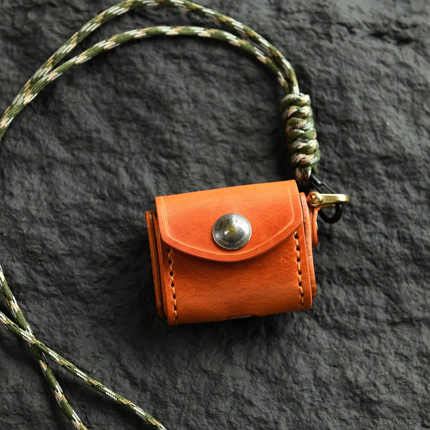 Sunset Tan cowhide earbud case with sun medallion and neck cord