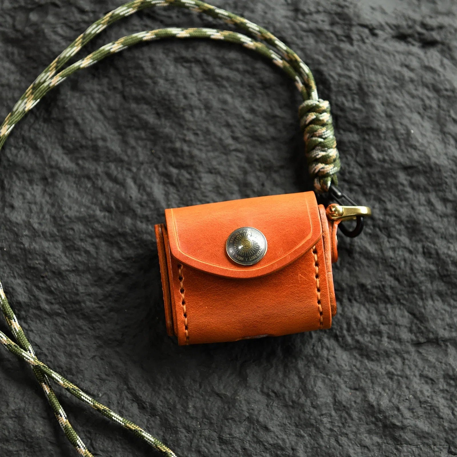 Sunset Tan cowhide earbud case with sun medallion and neck cord
